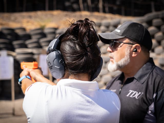 Alumna practicando puntería bajo la supervisión del instructor de tiro Jorge Chaves en el Tiro de Quilmes.